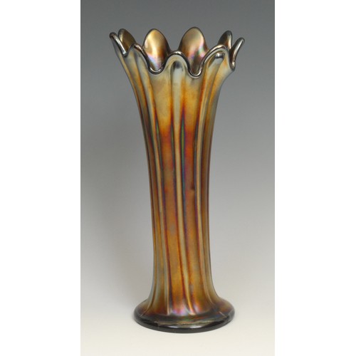 81 - An American Northwood carnival purple glass swung vase, fluted rim, iridescent reeds, 25.5cm; others... 