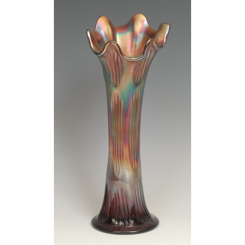 81 - An American Northwood carnival purple glass swung vase, fluted rim, iridescent reeds, 25.5cm; others... 