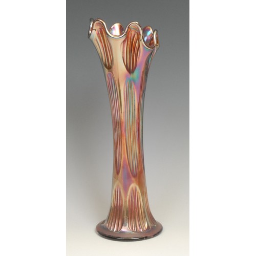 81 - An American Northwood carnival purple glass swung vase, fluted rim, iridescent reeds, 25.5cm; others... 