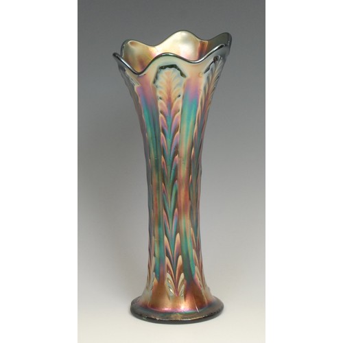 81 - An American Northwood carnival purple glass swung vase, fluted rim, iridescent reeds, 25.5cm; others... 