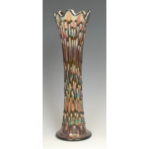 81 - An American Northwood carnival purple glass swung vase, fluted rim, iridescent reeds, 25.5cm; others... 