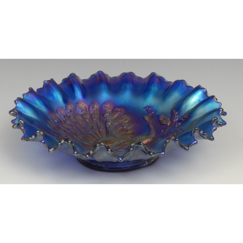80 - An American Northwood Carnival glass electric blue shaped circular bowl, moulded in low relief with ... 