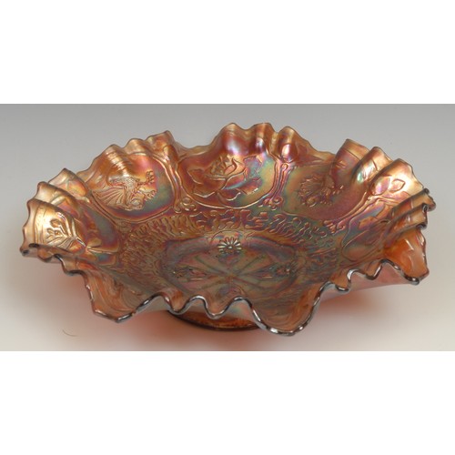 65 - A carnival amethyst glass fluted dish, moulded with dragons and roses in relief, 21cm diameter; a si... 