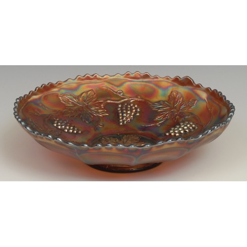 65 - A carnival amethyst glass fluted dish, moulded with dragons and roses in relief, 21cm diameter; a si... 