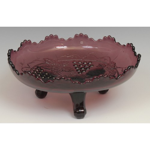 65 - A carnival amethyst glass fluted dish, moulded with dragons and roses in relief, 21cm diameter; a si... 