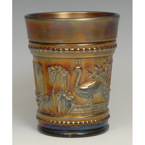 79 - An American Northwood amethyst carnival glass beaker, moulded with peacocks and fountains, 10cm, mou... 