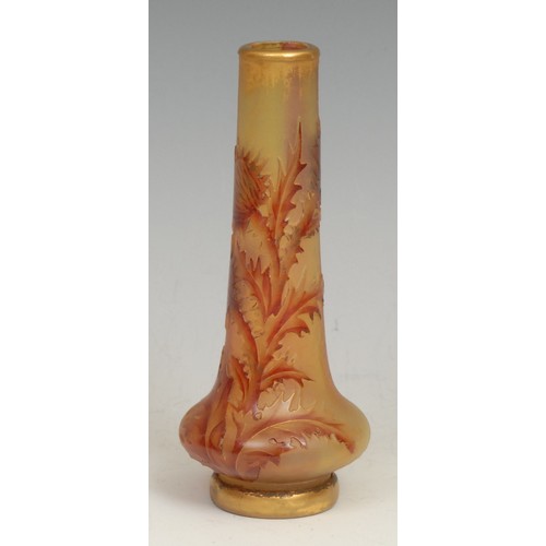 69 - A French Daum Nancy cameo glass bottle vase, incised with red thistles on an iridescent mottled gree... 