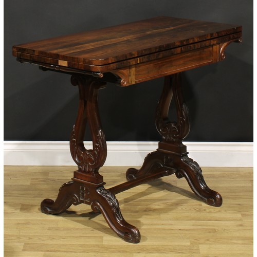 1568 - An unusual 19th century rosewood and mahogany card table, hinged top enclosing a baize lined playing... 