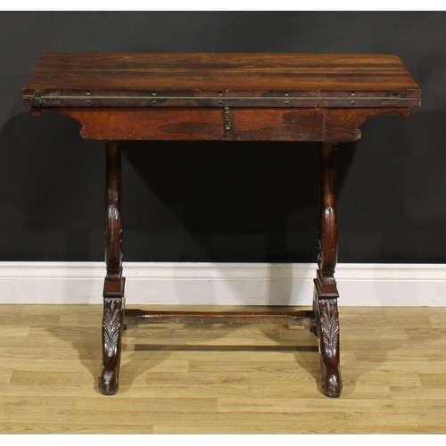 1568 - An unusual 19th century rosewood and mahogany card table, hinged top enclosing a baize lined playing... 