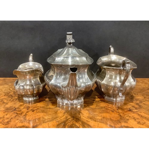 776 - An Edwardian silver half fluted three piece tea service, comprising teapot, sugar basin and cream ju... 