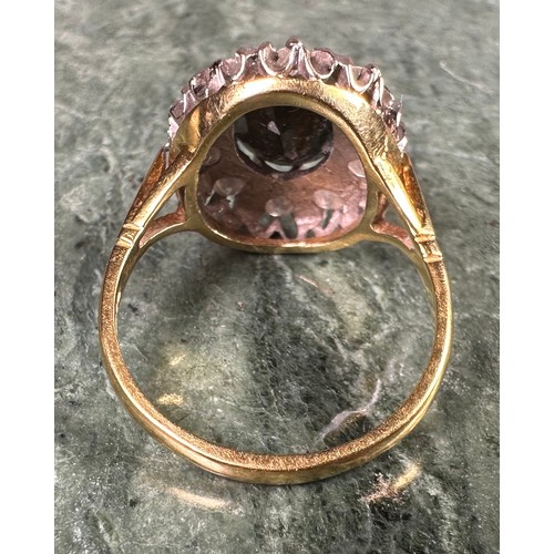 925 - An 18ct gold, diamond and sapphire oval cluster ring, the central stone claw set above a ring of old... 