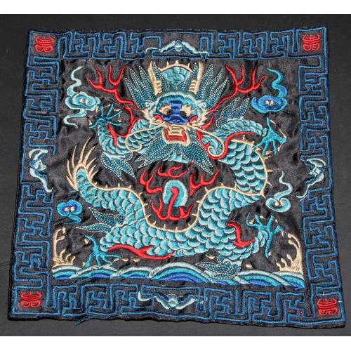 447 - A Chinese silk rank badge or Mandarin square, worked in coloured threads with a dragon, 26cm square;... 