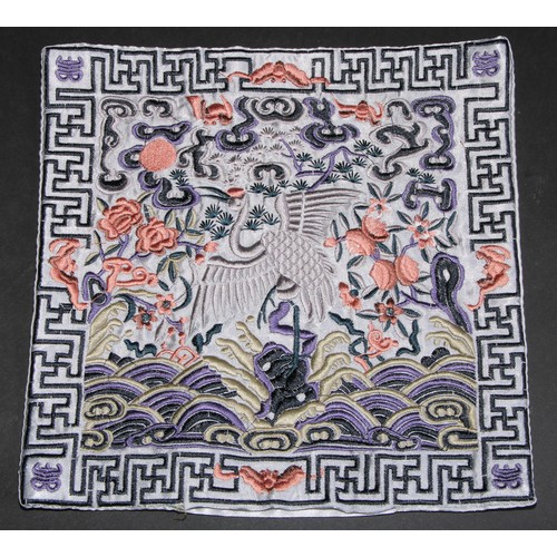 447 - A Chinese silk rank badge or Mandarin square, worked in coloured threads with a dragon, 26cm square;... 