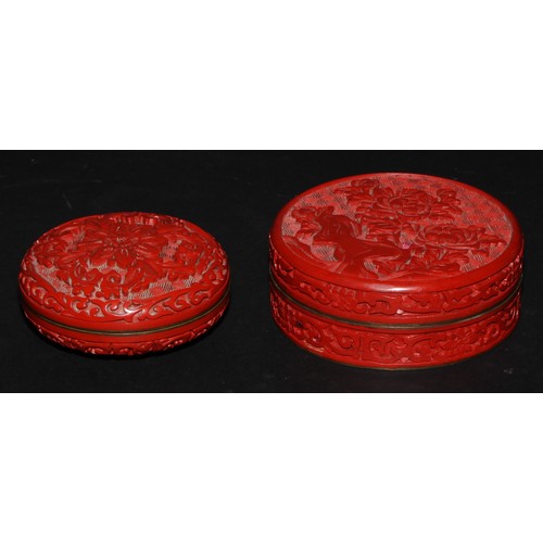 439 - A Chinese cinnabar lacquer circular box and cover, carved in relief with chrysanthemums on a diaper ... 