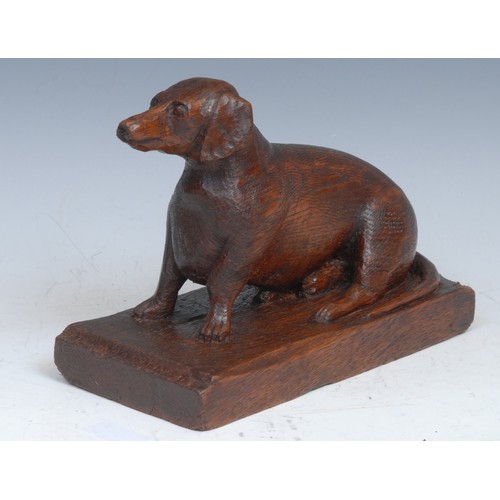 2089 - Folk Art - an oak carving, of a dachshund dog, rectangular base, 19cm wide, early 20th century