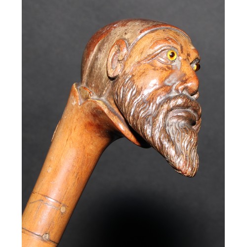 2213 - A 19th century walking stick or cane, the pommel carved as the head of a bearded man, wearing a fez,... 