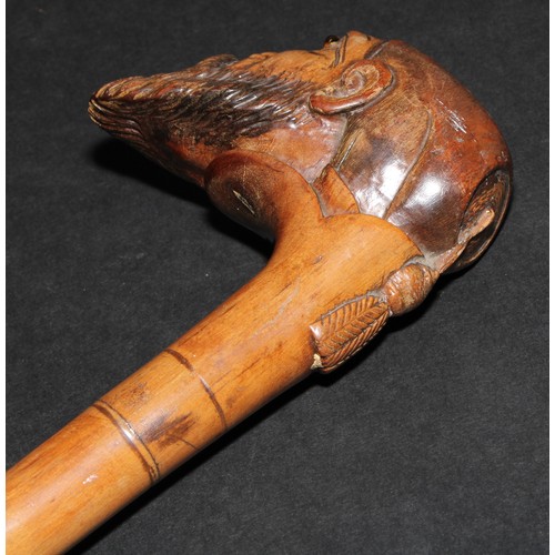 2213 - A 19th century walking stick or cane, the pommel carved as the head of a bearded man, wearing a fez,... 