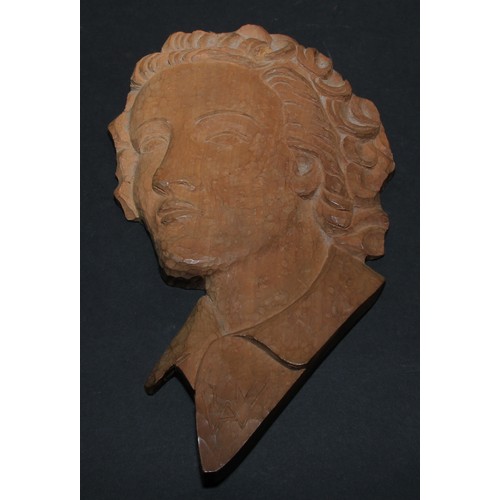 82 - An Art Deco carved beech portrait wall plaque, depicting a young lady, bust length, 26cm long, monog... 