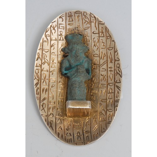 2574 - Antiquities - an Egyptian silver brooch, incorporating an Ancient turquoise faience votive or ushabt... 