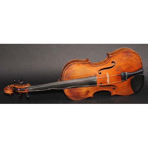 2561 - A violin, the two-piece back 35.5cm long excluding button, paper label printed Joseph Guarnerius, ro... 