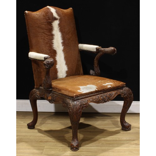 2106 - A pair of George II style mahogany Gainsborough chairs, boldly carved in the Irish Rococo taste with... 