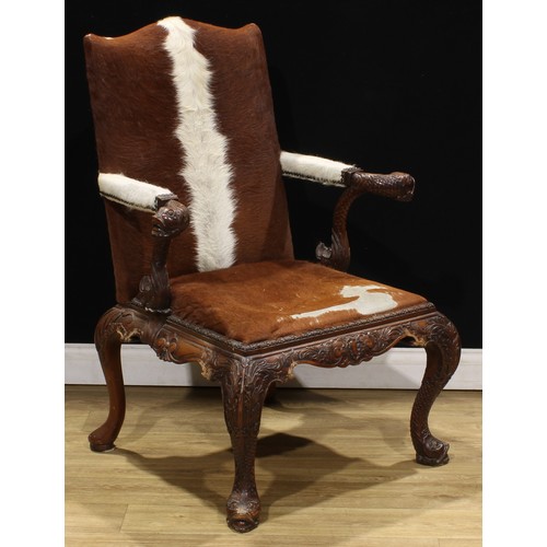 2106 - A pair of George II style mahogany Gainsborough chairs, boldly carved in the Irish Rococo taste with... 