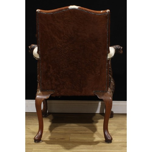 2106 - A pair of George II style mahogany Gainsborough chairs, boldly carved in the Irish Rococo taste with... 