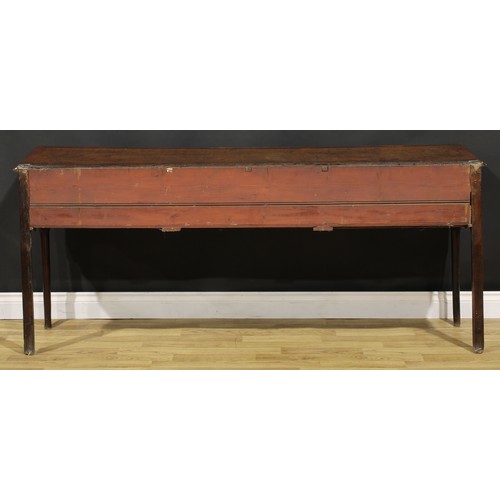 1305 - A George III mahogany crossbanded oak low dresser, slightly oversailing top above three frieze drawe... 