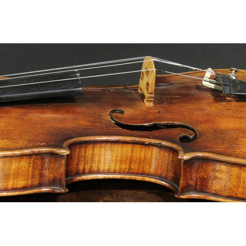 2559 - A violin, the one-piece back 35.5cm long excluding button, ebony tuning pegs, 60cm long overall, the... 