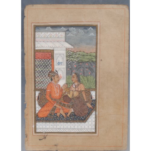 2696 - An Indian manuscript page, painted in watercolour and gouache with with an amorous couple, caligraph... 