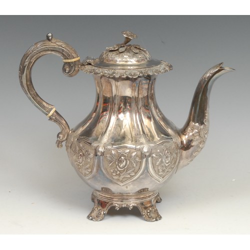 772 - An early Victorian silver teapot, chased in the Rococo Revival taste, flower finial, anthemion feet,... 