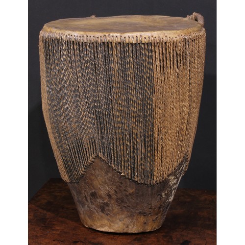 2533 - A Ugandan embuutu drum, hide bound hard wood, twin suspension loops, 39cm high, late 19th/early 20th... 