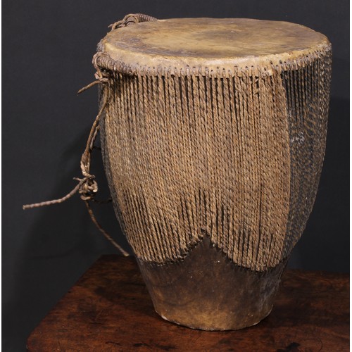 2533 - A Ugandan embuutu drum, hide bound hard wood, twin suspension loops, 39cm high, late 19th/early 20th... 