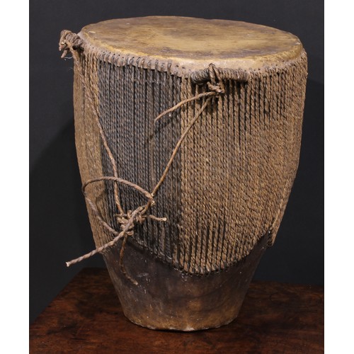 2533 - A Ugandan embuutu drum, hide bound hard wood, twin suspension loops, 39cm high, late 19th/early 20th... 