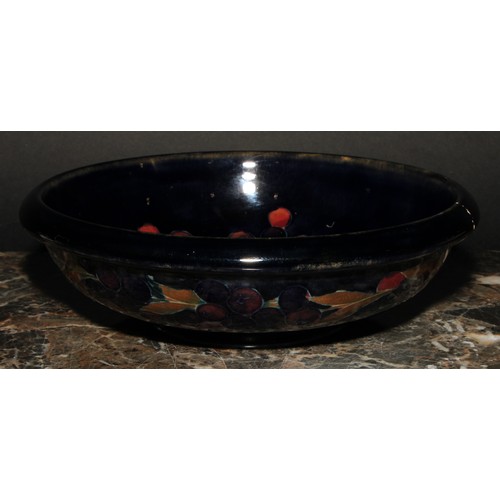 7 - A Moorcroft Pomegranate pattern circular bowl, tube lined with large fruit and berries, on a mottled... 