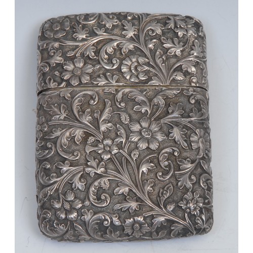 812 - An Indian silver rounded rectangular visiting card case, of substantial gauge, profusely chased with... 