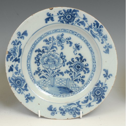 108 - An 18th century Delft circular plate, painted in the Chinese taste with precious objects and chrysan... 
