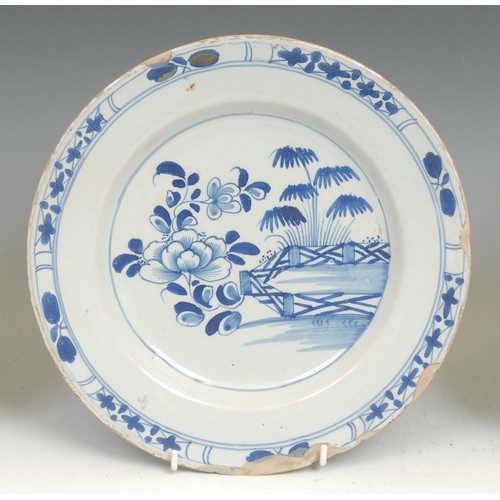 108 - An 18th century Delft circular plate, painted in the Chinese taste with precious objects and chrysan... 