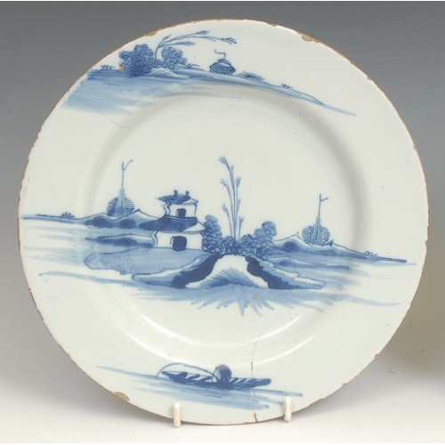 108 - An 18th century Delft circular plate, painted in the Chinese taste with precious objects and chrysan... 