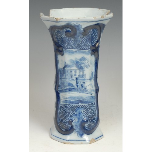 111 - An 18th century Delft night light, moulded with masks and painted in tones of blue with leaves and f... 
