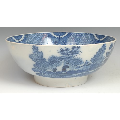 101 - A pearlware navette shaped pedestal dish, printed in tones of underglaze blue with a basket of flowe... 