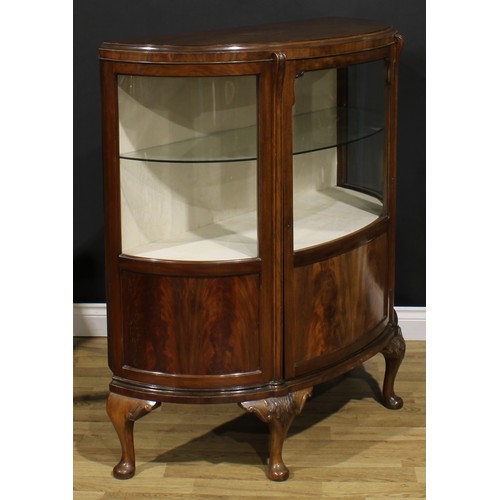 2068 - A George II Revival walnut demi-lune side cabinet, moulded top above a glazed door and rectangular p... 