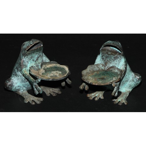 2179 - A pair of verdigris patinated novelty candle waiters, each cast as a frog, 10cm high