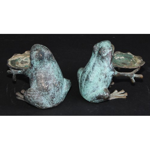 2179 - A pair of verdigris patinated novelty candle waiters, each cast as a frog, 10cm high