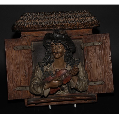 2207 - An Austrian terracotta plaque, as a musician at a window, in Renaissance dress, 34cm wide, impressed... 