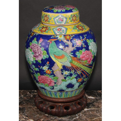 340 - A large Japanese ovoid ginger jar and cover, decorated in polychrome enamels, with a fanciful bird a... 