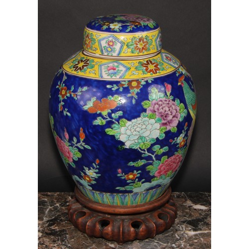 340 - A large Japanese ovoid ginger jar and cover, decorated in polychrome enamels, with a fanciful bird a... 