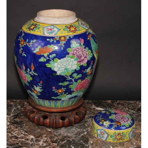 340 - A large Japanese ovoid ginger jar and cover, decorated in polychrome enamels, with a fanciful bird a... 