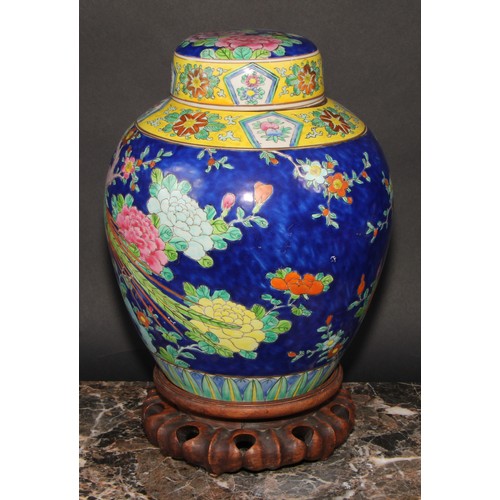 340 - A large Japanese ovoid ginger jar and cover, decorated in polychrome enamels, with a fanciful bird a... 