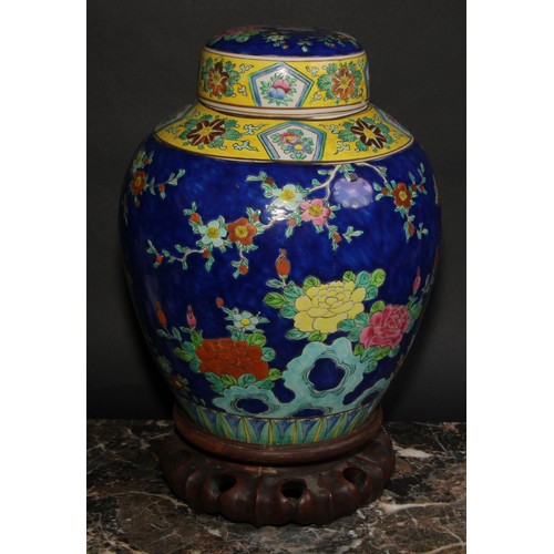 340 - A large Japanese ovoid ginger jar and cover, decorated in polychrome enamels, with a fanciful bird a... 